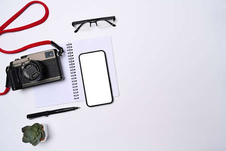 Digital tablet, laptop, smart phone and notepad on wooden background.