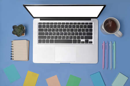 Mock up laptop with empty screen and orange accessories beige background.の写真素材