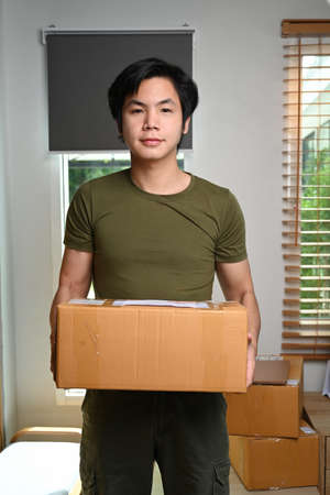 Asian man business owner prepare product packaging cardboard box for customer.の写真素材