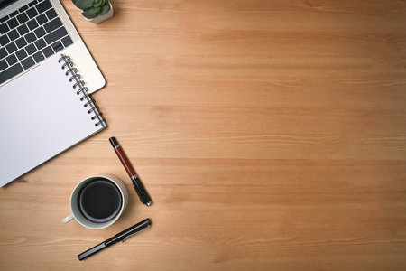Mock up computer laptop, notepad and coffee cup on wooden background.の写真素材