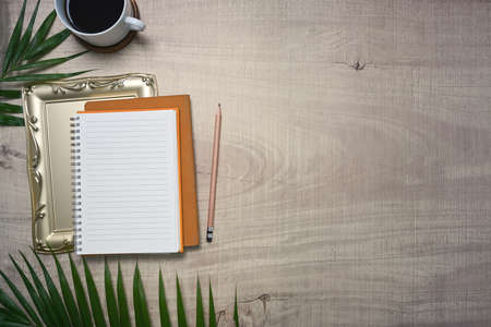 Mock up computer laptop, notepad and coffee cup on wooden background.の写真素材