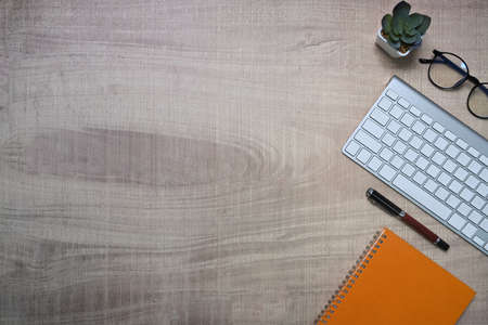 Mock up computer laptop, notepad and coffee cup on wooden background.