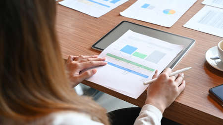 Businesswoman reading reports  at office desk.の写真素材