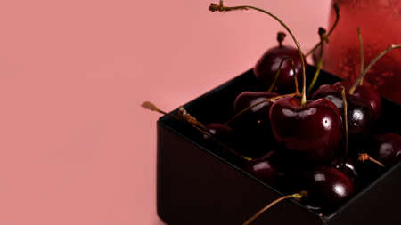 Close up female picking up fresh cherry.の写真素材