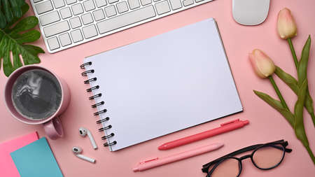 Alarm clock, pencil holder and notebook on wooden table.の写真素材