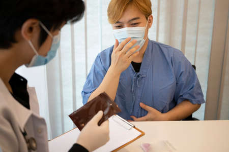 Doctor using stethoscope examination his patient in hospital.の写真素材