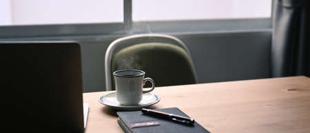 Close up computer laptop with blank display on wooden table.の写真素材