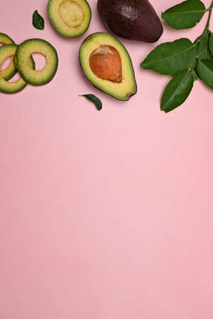 Half avocado on pink background.の写真素材