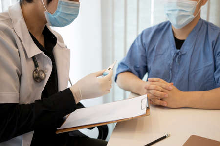 Doctor is consulting with his patient in hospital.