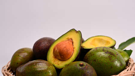 Whole and half avocado isolated on white background. Healthy food concept.の写真素材
