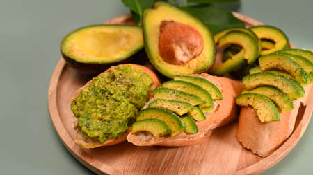 Avocado on pink background. Healthy fruits concept.