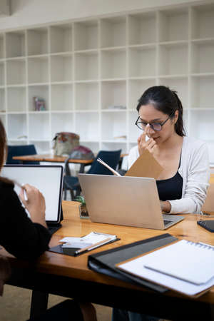 Group of creative people working on their project together in office.