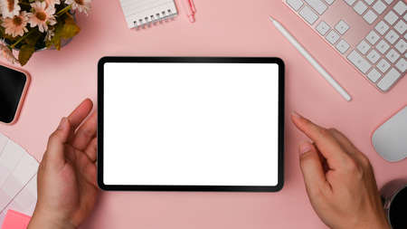 Above view woman holding mock up digital tablet with empty screen.
