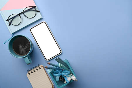 Cup of coffee, glasses and notebook on red background.の写真素材