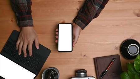 Top view, wireless keyboard, coffee cup and notebook on red background.の写真素材