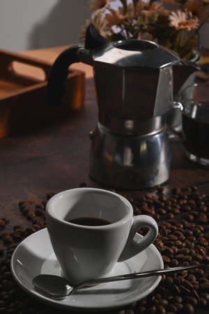 A cup of coffee and coffee beans on rustic wooden background.の写真素材