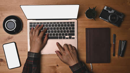 Man photographer working with laptop computer at his workspace.の写真素材