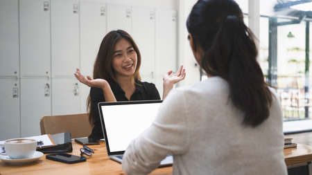 Two female designer working together on their new project at creative office.