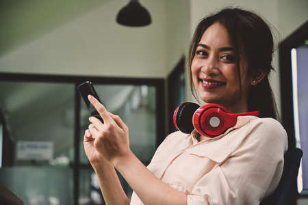 Attractive young woman sitting in coffee shop and working with laptop computer.