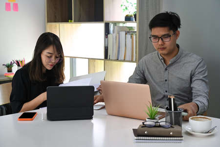 Two business colleagues working together on new project in modern office.