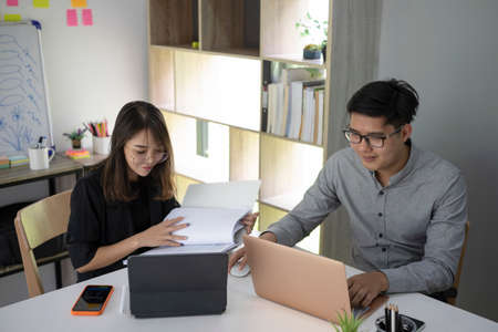 Two business colleagues working together on new project in modern office.