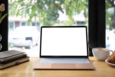 Digital tablet and laptop computer on wooden table.の写真素材