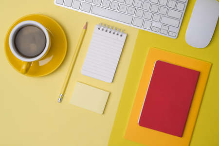 Top view white office desk with smart phone, headphone and coffee cup.の写真素材