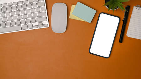 Mock up computer, notebook an sticky notes on brown leather.の写真素材