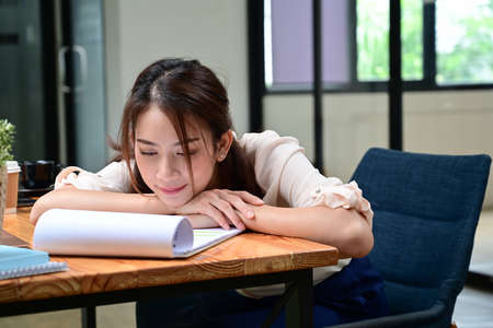 Tired businesswoman resting on her office desk.の写真素材