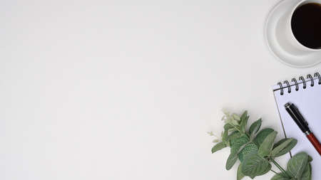 A coffee cup, notebook and pen on white background with copy space.の写真素材
