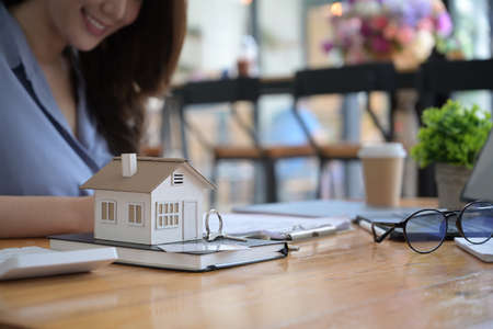 Real estate agent discussing for contract to buy house with her customer.の写真素材