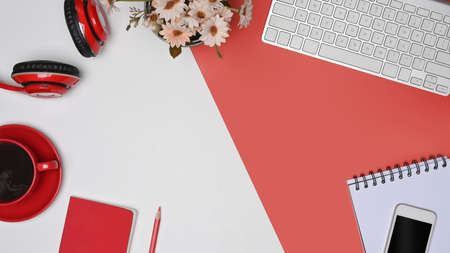 Top view, coffee cup, headphone, smart phone and notebook on red and white background.の写真素材