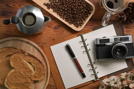 Above view woman spreads peanut butter on toast for a healthy breakfast.の写真素材