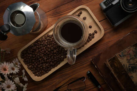 Above view cup of coffee and moka pot on wooden table.の写真素材