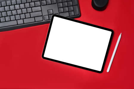 Top view digital tablet with empt display on red background.の写真素材