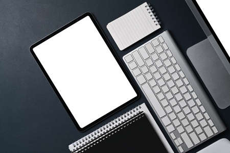 Digital tablet, computer and notebook on black leather.