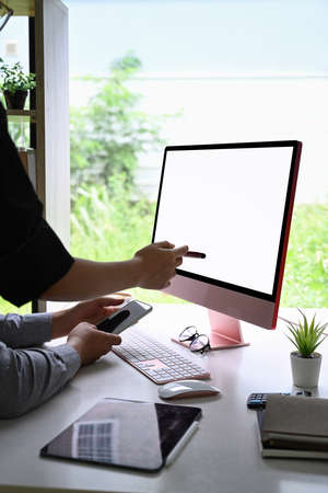 Businesspeople working together in bright office room.