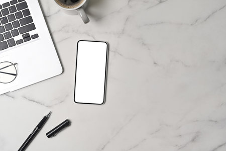 Mock up smart phone, laptop computer and coffee cup on marble background.の写真素材