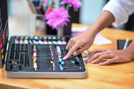 Close up view of creative woman hands choosing color for her design project.の写真素材