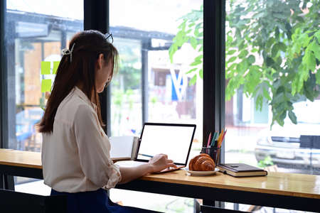 Smiling businesswoman using digital tablet at office.の写真素材