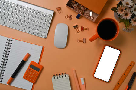 Mock up mobile phone, coffee cup, notebook and calculator onaccountant workspace.の写真素材