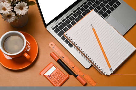 Computer laptop, coffee cup, notebook and calculator on accountant workspace.の写真素材