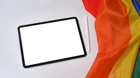 Digital tablet and LGBT pride flag on white background.の写真素材