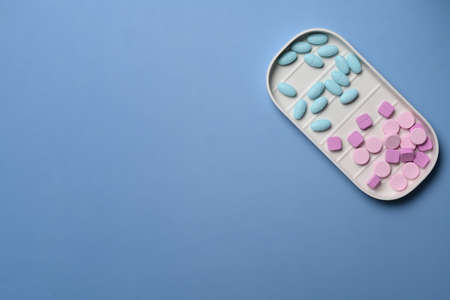 Medicine pills on blue background. Pharmacy and healthcare concept .の写真素材