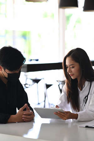 Cropped shot doctor giving a consultation to a patient and explaining medical informations and diagnosis.の写真素材