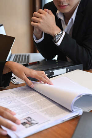 Cropped shot team of human resources reading cv resume before interview candidature.