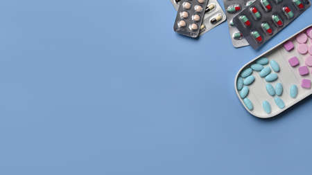 Medical pills on blue background. Health care and medicine concept.の写真素材