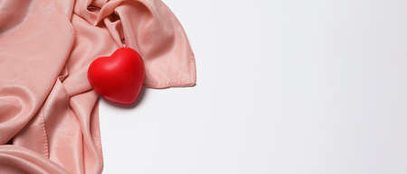 Red heart rubber on white background with copy space. Cardiology and insurance concept.の写真素材