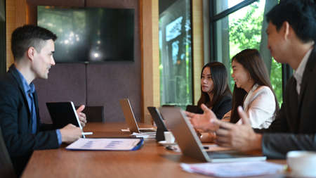 Cropped shot corporate executives discussing business strategy together in meeting room.の写真素材