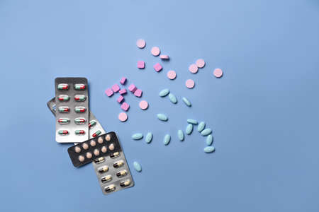 Blister packs and medical pills on blue background.の写真素材